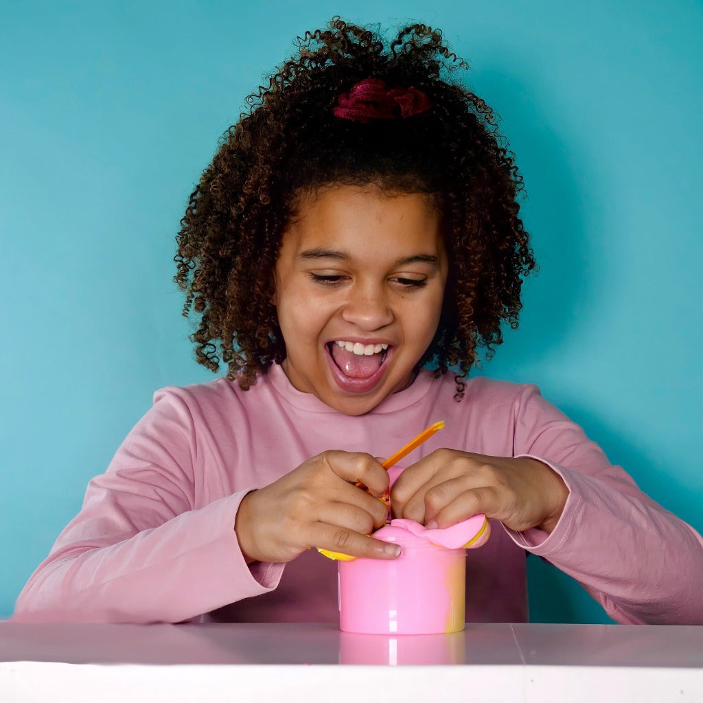 Child loving their birthday cake pop slime!