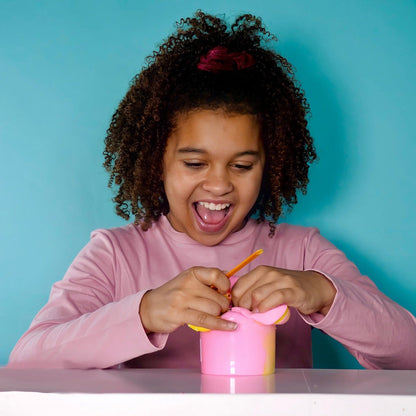 Child loving their birthday cake pop slime!